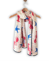 Coastal Reverie — A sophisticated blend of coastal-inspired motifs, vibrant coral reds, deep ocean blues, and soft ivory hues.